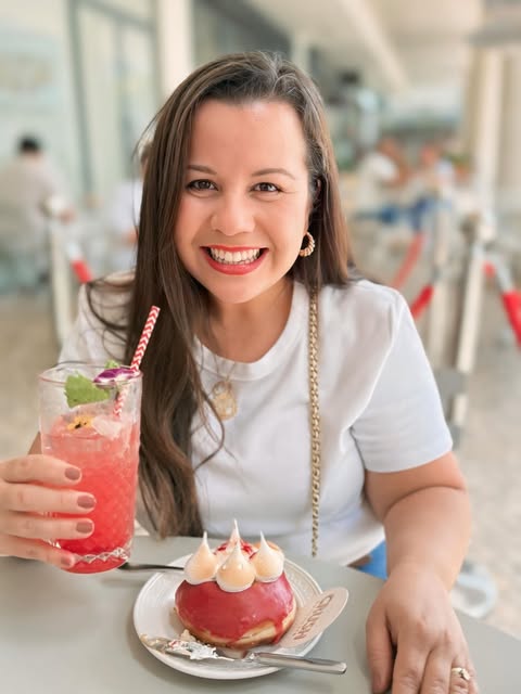 Guest with a pink glazed doughnut